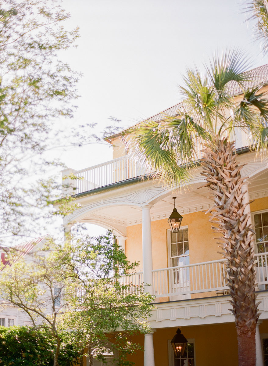 View of William Aiken House, wedding venue in Charleston, SC with a palm tree