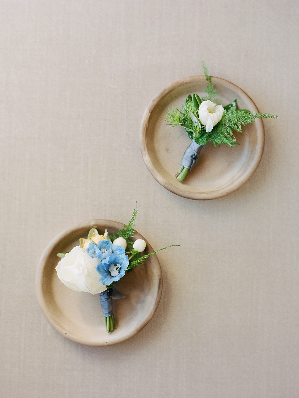 early spring boutonnieres in terra cotta clay dishes
