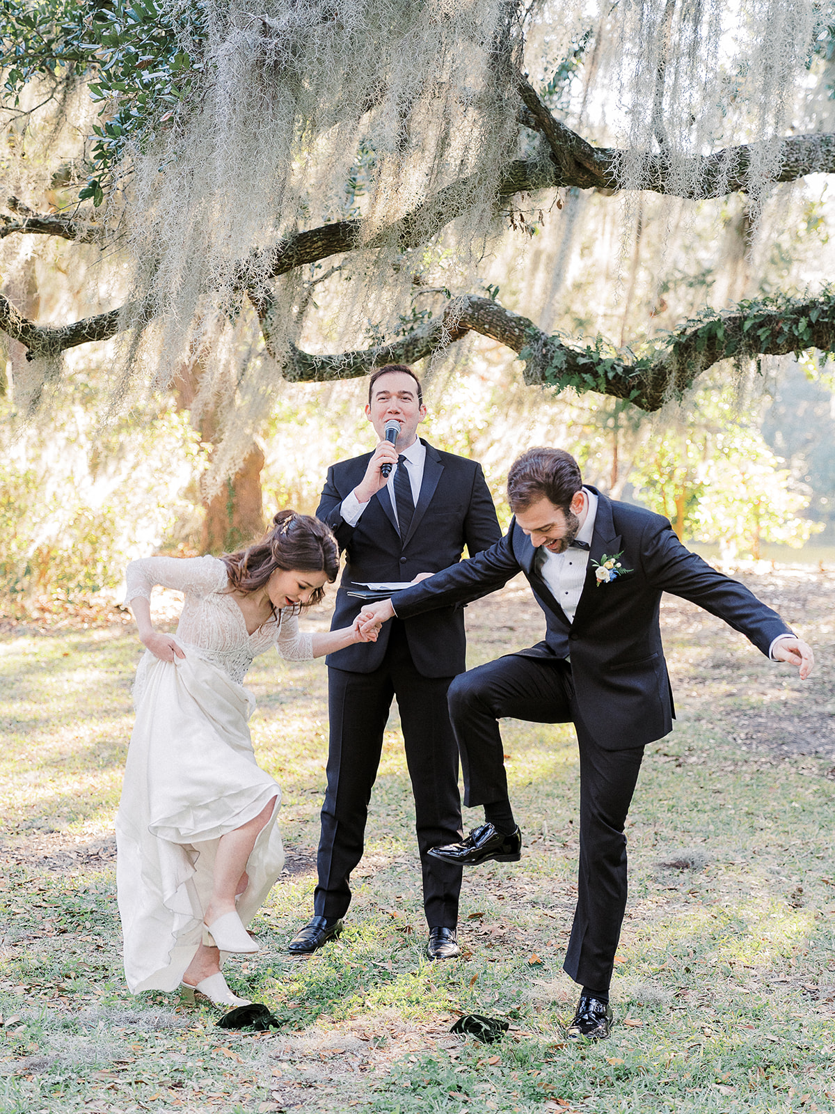 Charleston wedding ceremony beneath a live oak with spanish moss as bride and groom break the glass per Jewish wedding traditions; planning and design by Willow and Oak Events with photography by Kylee Yee