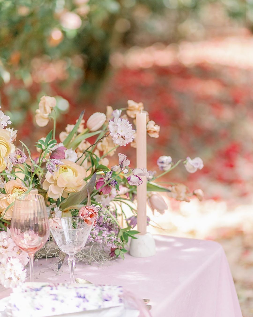 Peach, violet and butter garden wedding centerpiece on a pink velvet table at Middleton Place, captured by Sacia Matthews Photography and styled by Willow and Oak Events