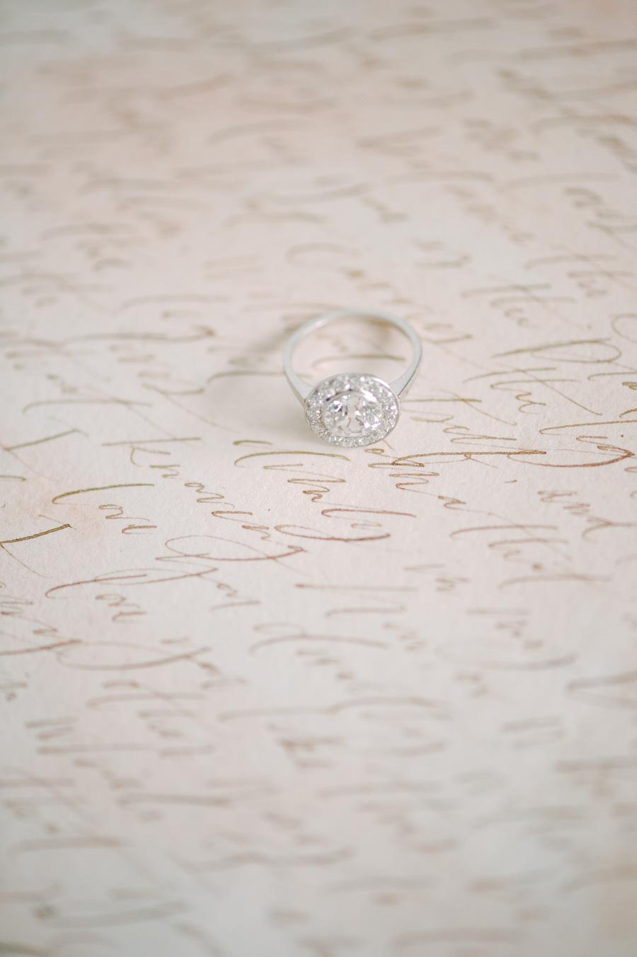 Fine art wedding calligraphy with a round antique engagement ring and diamond halo | Photo by Julie Livingston with planning + design by Willow and Oak Events