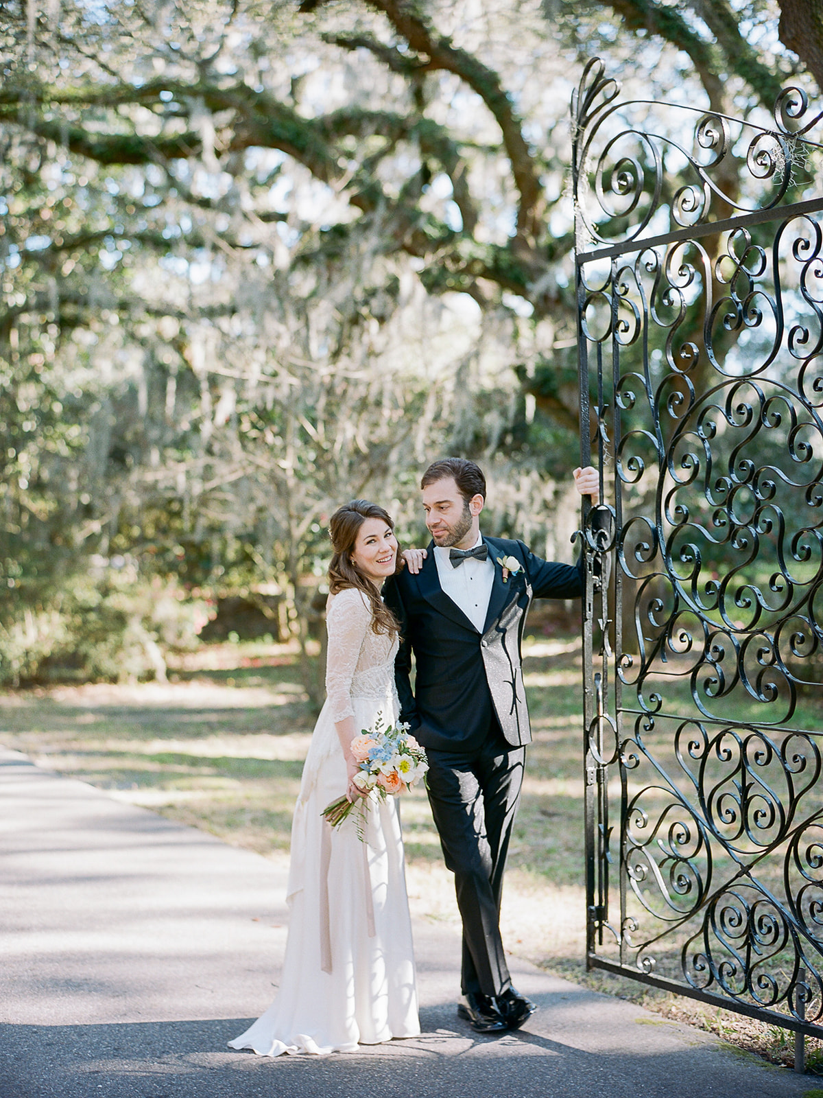 Winter wedding in Charleston with a vintage inspired wedding dress and black groom tux, designed by destination wedding planner Willow and Oak Events and captured by Kylee Yee Photography