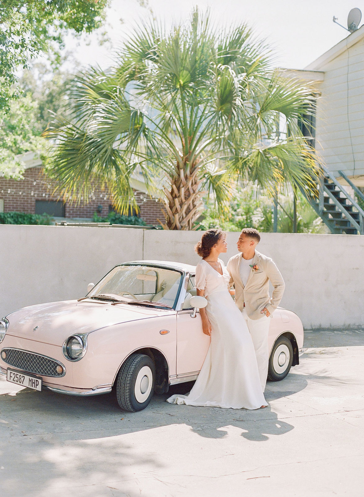 '91 Pink Figaro wedding getaway car for a Charleston wedding captured by Clay Austin and planned by Willow and Oak Events