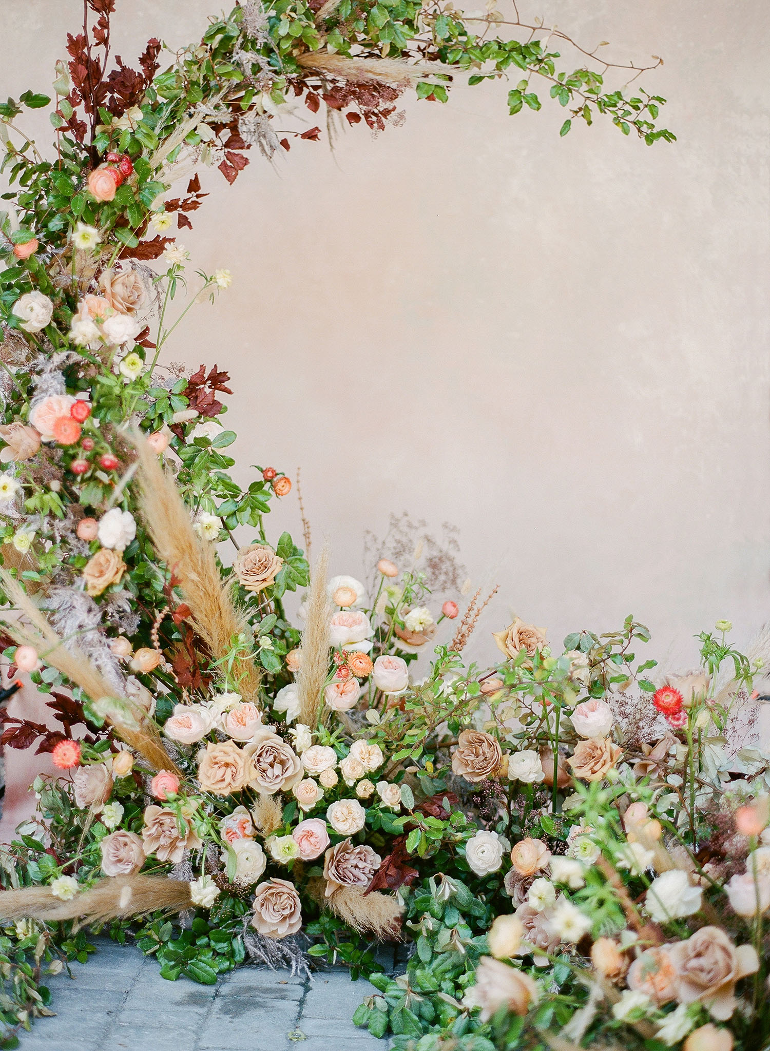 Overgrown floral crescent wedding backdrop from Festoon Charleston with planning and design by Willow & Oak Events and photography by Clay Austin