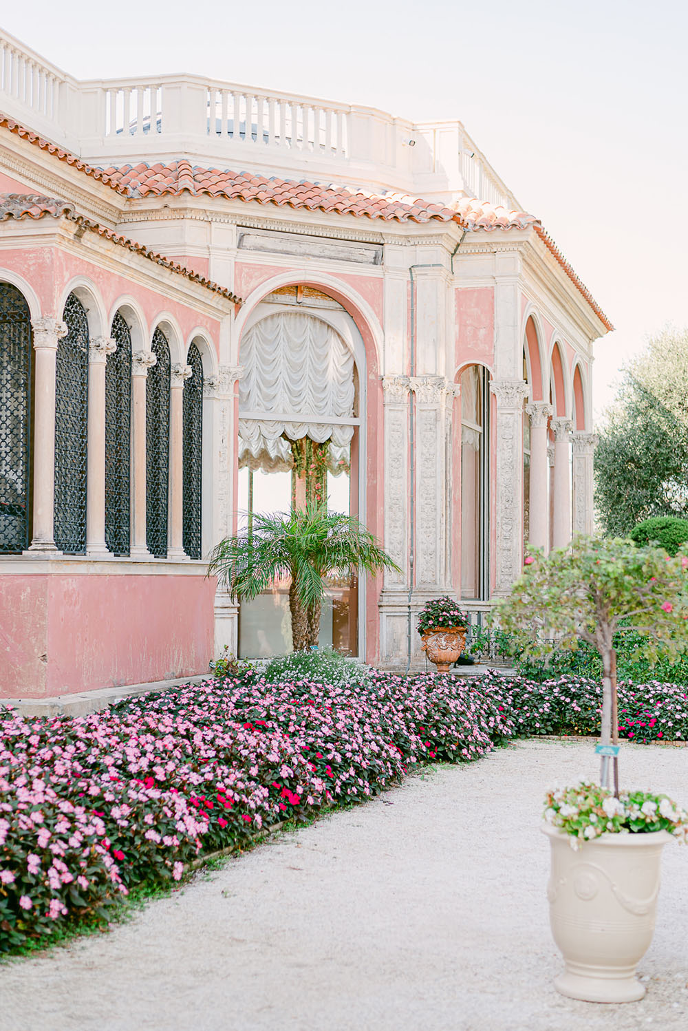 Pink and cream exterior of Villa Ephrussi de Rothschild in the French Riviera