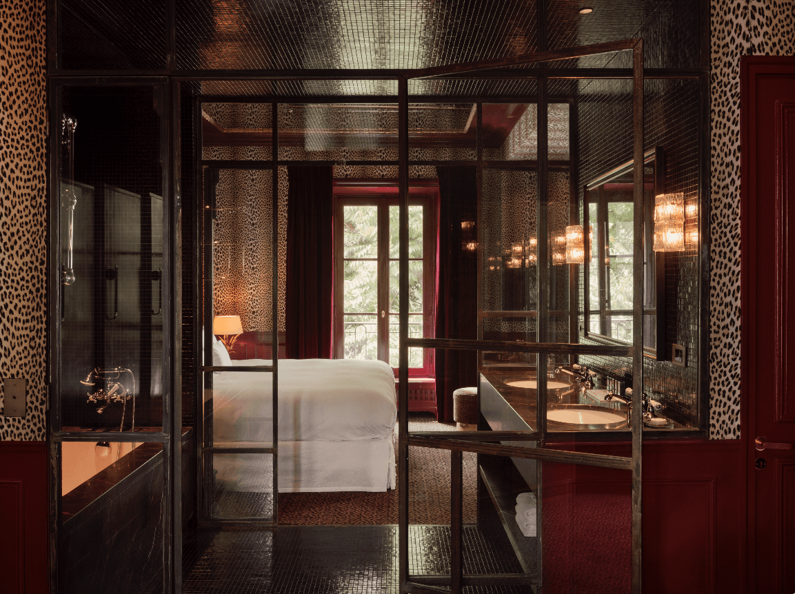A leopard print wallpaper and red wainscoting for one of the guestrooms at Hôtel Particulier Montmartre