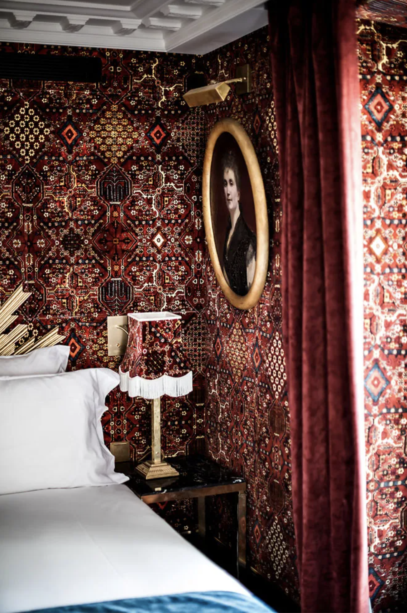 A Mini Room at Hotel Providence Paris with kilim-print velvet, custom fringed lampshades and sunburst headboards