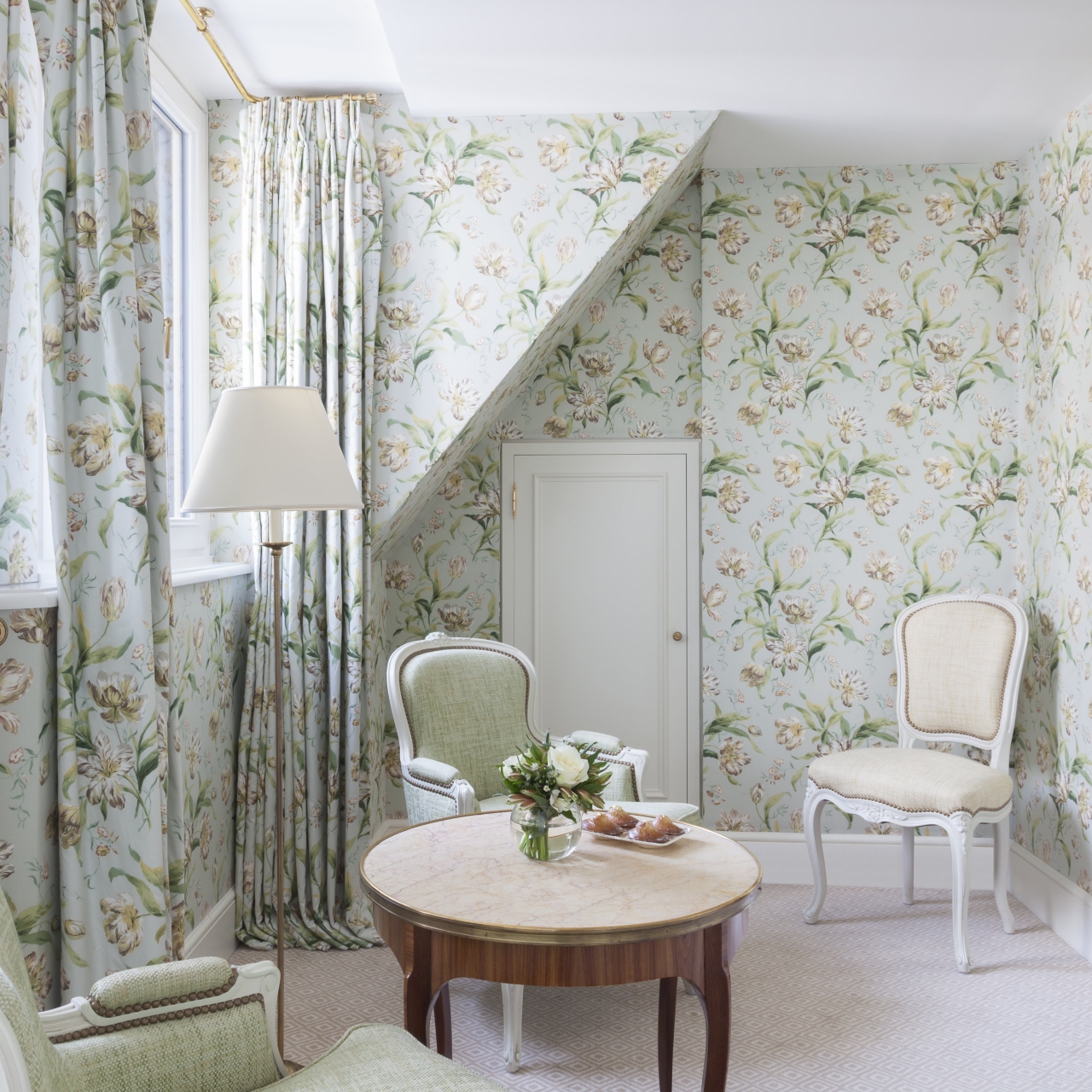 A romantic floral wallpapered guest room at Le Bristol Paris in tender shades of robin's egg blue and sage green