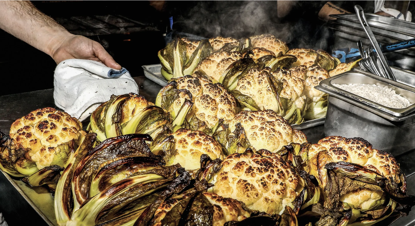 Roasted cauliflower during preparation at Miznon Paris