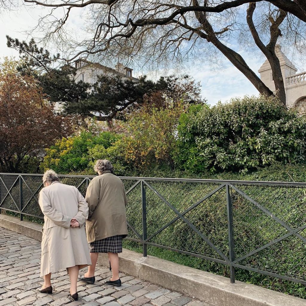 A pair of old ladies walking up a cobblestone street in Montmartre